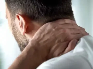 man holding his neck in pain