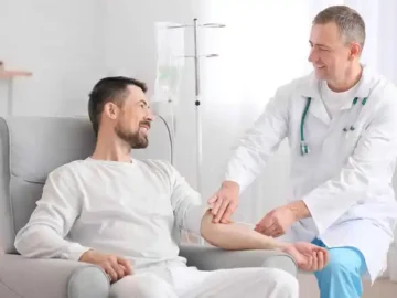 Doctor setting up an infusion for a patient