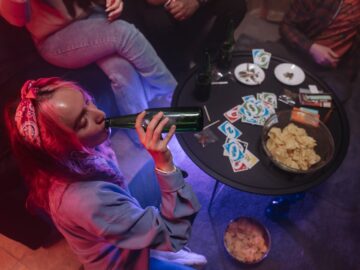 Young girl drinking beer, smoking weed at a home party